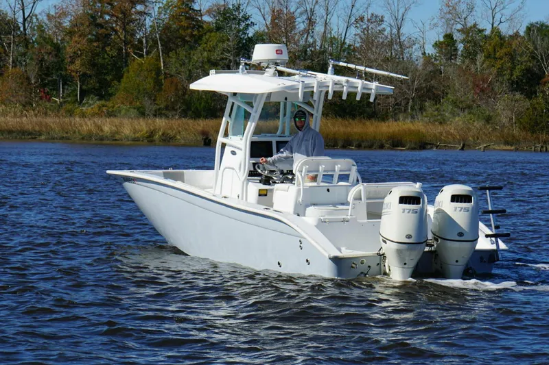 Slide: The Image of 2018 Cape Horn 24 XS boat cruising on a scenic river with dual engines. - 5