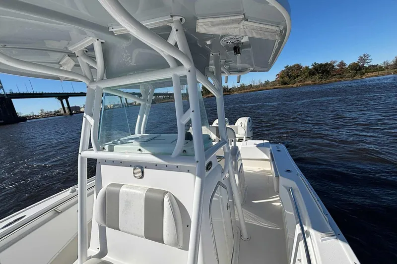 Slide: The Image of 2018 Cape Horn 24 XS boat on water, featuring sleek design and spacious deck. - 15