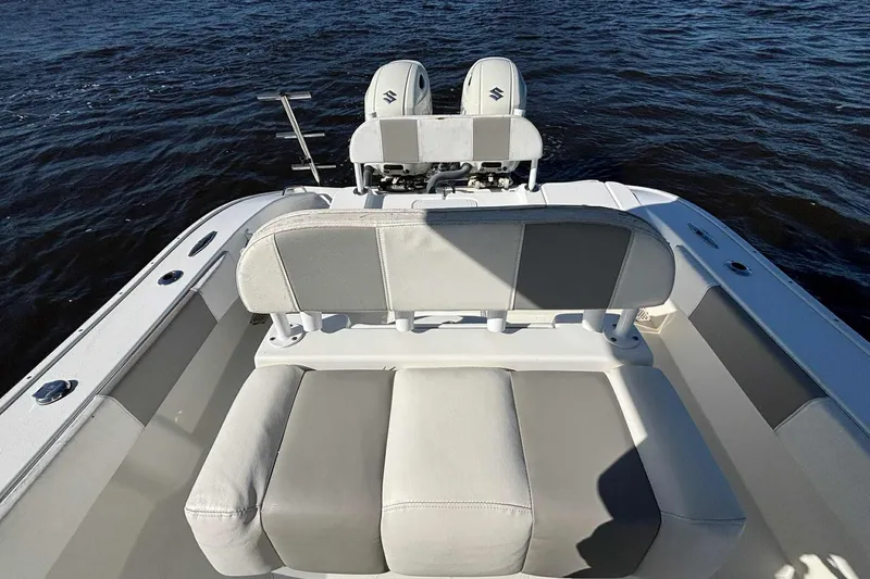Slide: The Image of 2018 Cape Horn 24 XS boat with dual engines and cushioned seating on open water. - 17