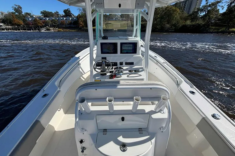Slide: The Image of 2018 Cape Horn 24 XS boat interior with steering console on a sunny day. - 18