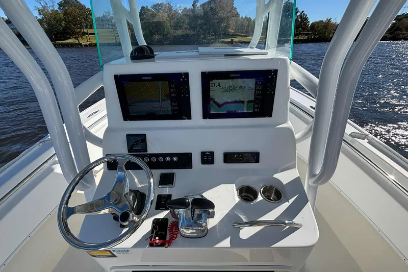Slide: The Image of 2018 Cape Horn 24 XS boat console with dual navigation screens and steering wheel. - 21