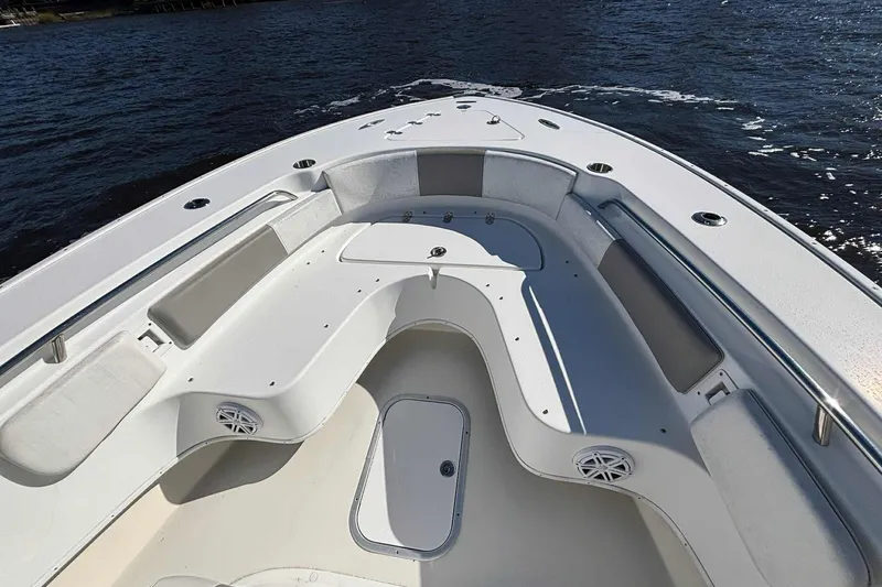 Slide: The Image of 2018 Cape Horn 24 XS boat interior with seating and storage, on calm water. - 22