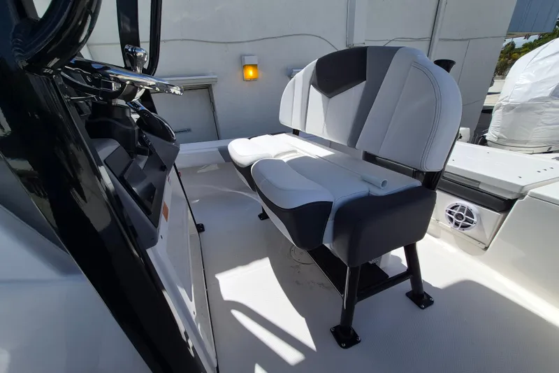Slide: The Image of 2026 Robalo 246 Cayman boat interior with modern seating and steering console. - 13