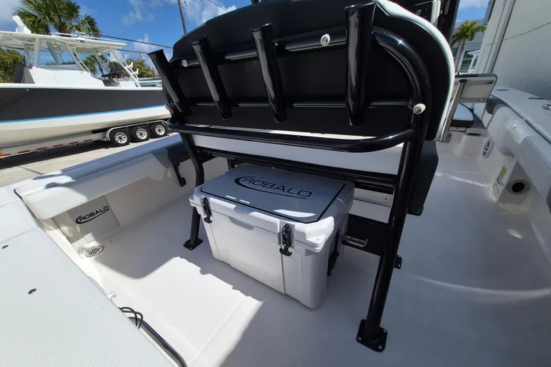 Slide: The Image of 2026 Robalo 246 Cayman boat interior with cooler and seating. - 18