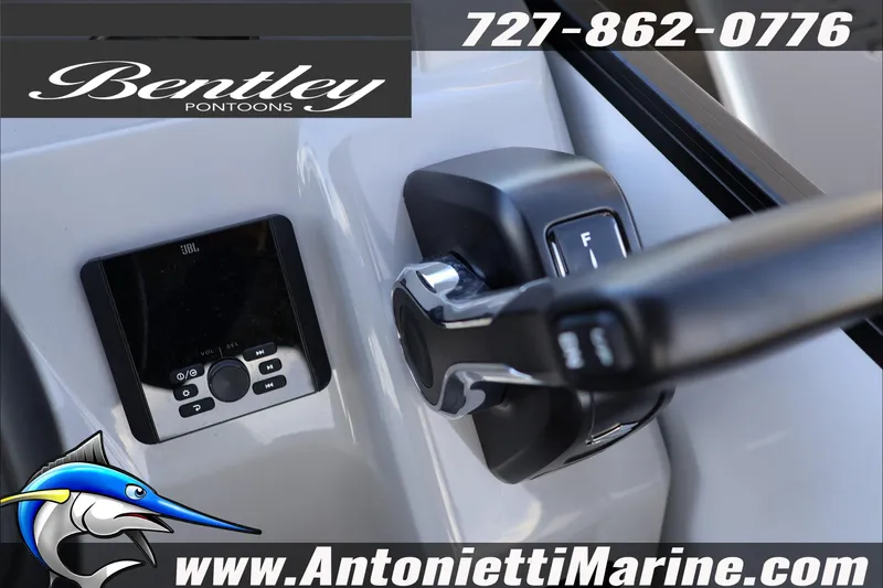 Slide: The Image of 2026 Bentley Pontoons Bolt 223 dashboard with controls and JBL audio system. - 13