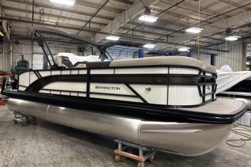 The Image of 2026 Bennington 22 S Swingback pontoon boat in a warehouse setting. - 1
