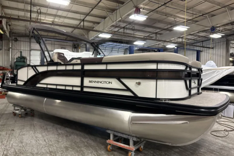 Slide: The Image of 2026 Bennington 22 S Swingback pontoon boat in a warehouse setting. - 10