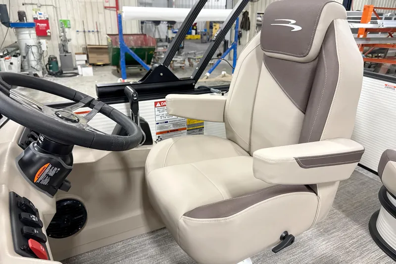 Slide: The Image of 2026 Bennington 22 S Swingback boat interior with steering wheel and captain's chair. - 7