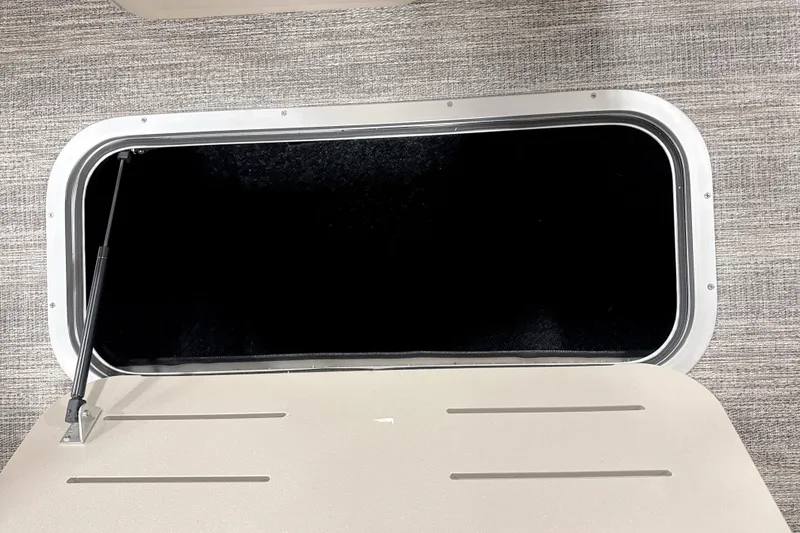 Slide: The Image of Open storage compartment in 2026 Bennington 22 S Swingback boat, featuring a sleek design. - 8