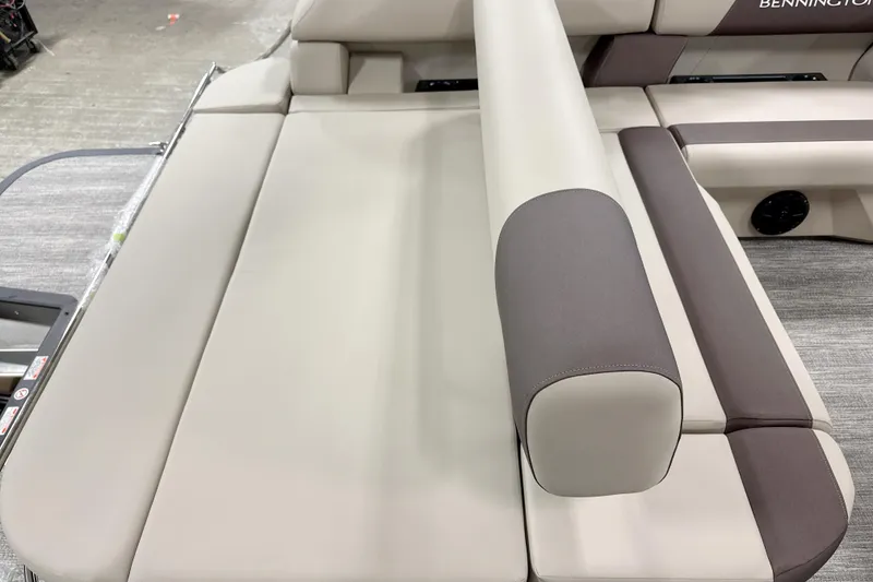 Slide: The Image of 2026 Bennington 22 S Swingback boat interior with beige and brown seating. - 9