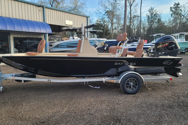 Slide: The Image of 2026 G3 Bay 19 GX boat on trailer, displayed outdoors at dealership. - 0