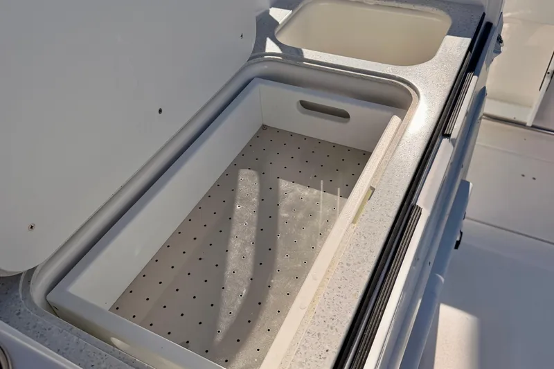 Slide: The Image of 2026 Sea Fox 328 Commander boat storage compartment with integrated sink. - 25