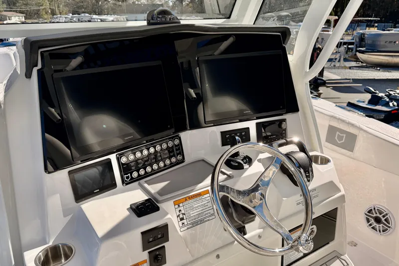 Slide: The Image of 2026 Sea Fox 328 Commander boat dashboard with dual screens and modern controls. - 29