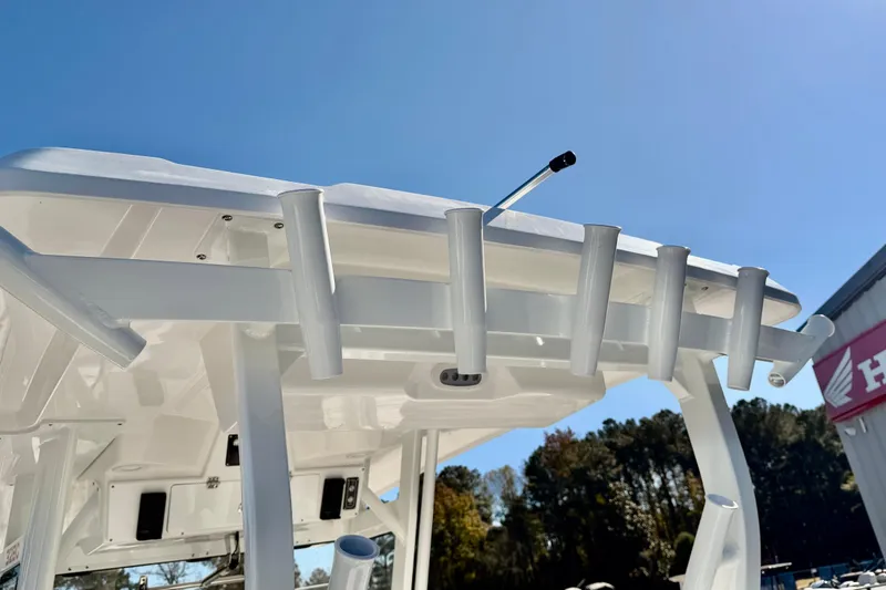Slide: The Image of 2026 Sea Fox 328 Commander boat with rod holders under clear blue sky. - 35