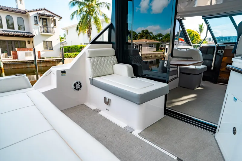 Slide: The Image of 2022 Regal 36 XO yacht interior with luxurious seating and modern design. - 13