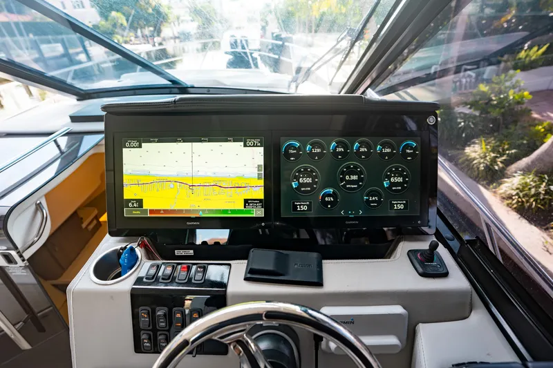 Slide: The Image of 2022 Regal 36 XO helm with dual Garmin displays and control panel. - 16