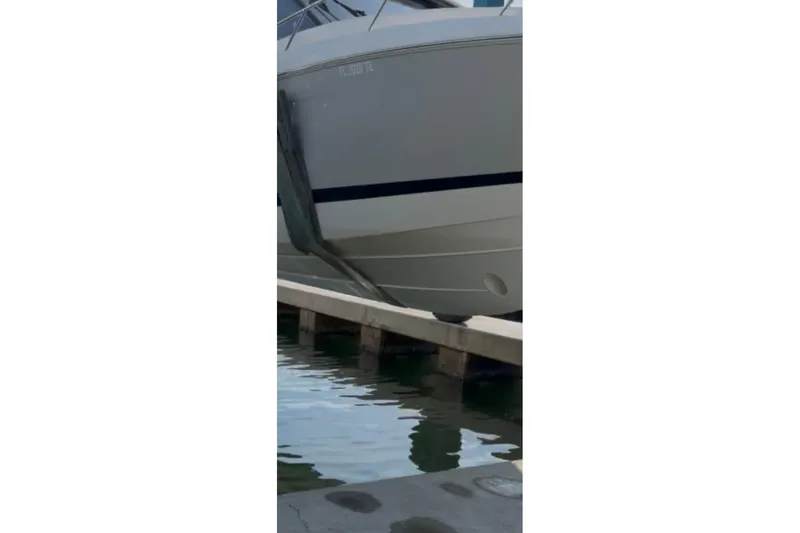 Slide: The Image of 2022 Regal 36 XO boat docked at marina, side view. - 2