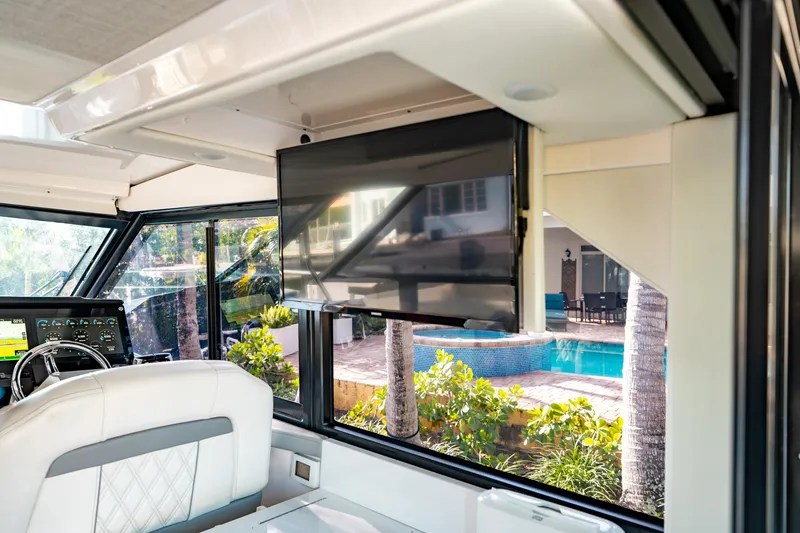 Slide: The Image of Interior of 2022 Regal 36 XO yacht with TV and poolside view. - 21