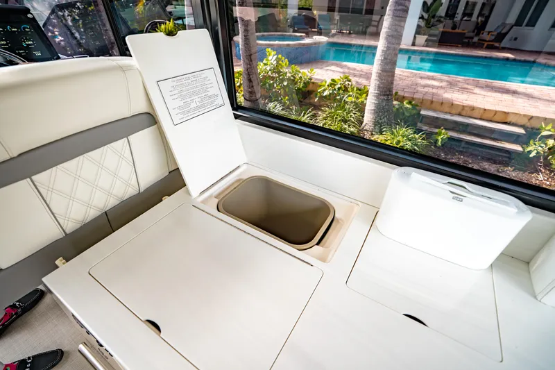 Slide: The Image of Interior of 2022 Regal 36 XO yacht with open storage compartment, near pool view. - 25