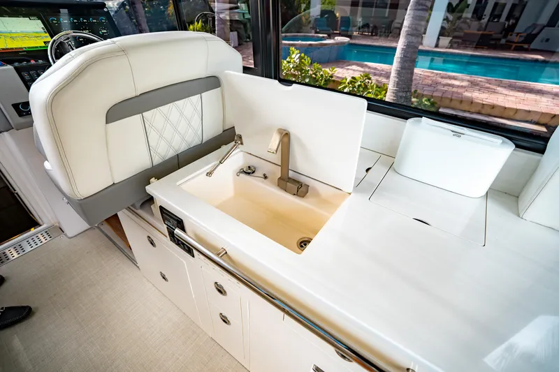 Slide: The Image of 2022 Regal 36 XO yacht interior with sink and seating area. - 27