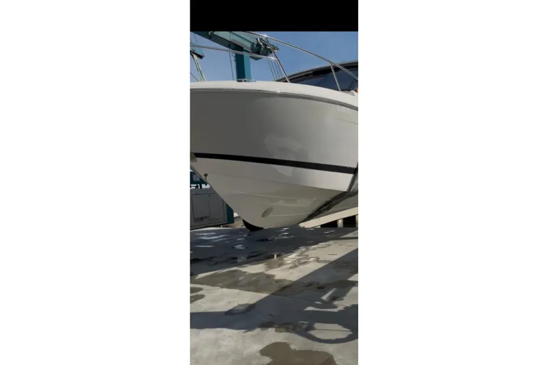 Slide: The Image of 2022 Regal 36 XO boat on dry dock, showcasing sleek hull design. - 3