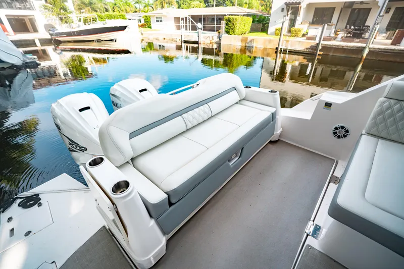 Slide: The Image of 2022 Regal 36 XO boat interior with waterfront view and palm trees. - 33