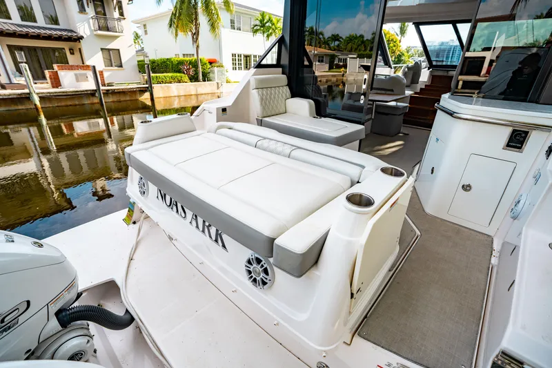 Slide: The Image of 2022 Regal 36 XO boat with spacious white seating and sleek design. - 36