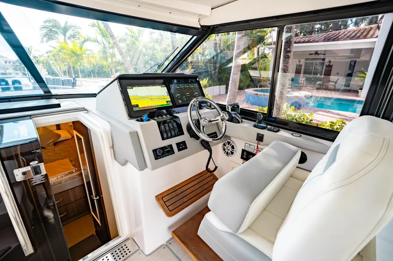 Slide: The Image of 2022 Regal 36 XO yacht interior closet with hangers, hat, and storage box. - 43