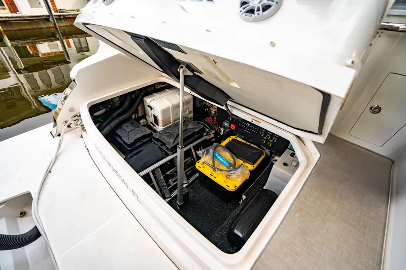 Slide: The Image of 2022 Regal 36 XO boat engine compartment with open hatch, showing equipment and wiring. - 8