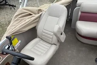 Slide: The Image of 2013 Premier 220 SunSation boat interior with beige seating and steering wheel. - 6