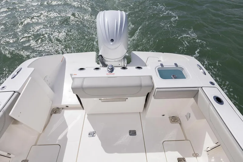 Slide: The Image of Manufacturer Provided Image: 2025 Pursuit S 248 Sport boat deck with motor and seating, on water. - 16