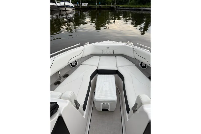 Slide: The Image of 2023 Regal LX4 boat interior with white seating and water view. - 13