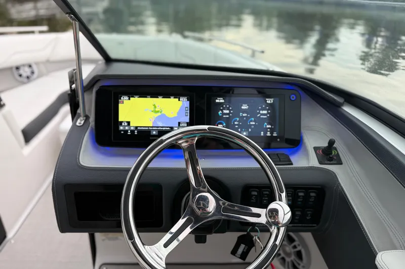Slide: The Image of 2023 Regal LX4 boat dashboard with dual displays and steering wheel. - 8