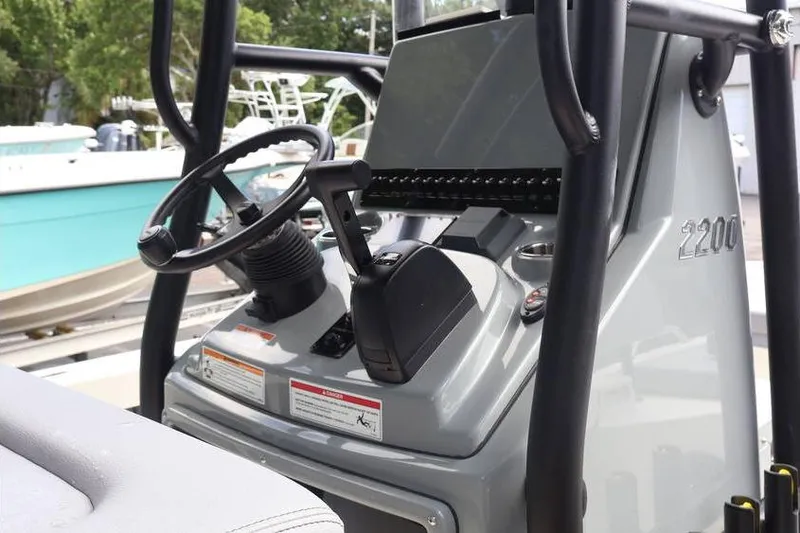 Slide: The Image of 2025 Pathfinder 2200 TRS boat console with steering wheel and controls. - 14