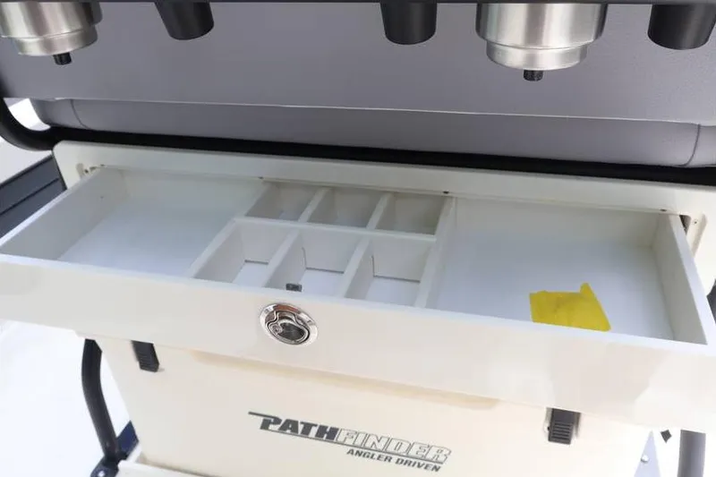 Slide: The Image of 2025 Pathfinder 2200 TRS boat storage compartment with organized sections and secure lock. - 19
