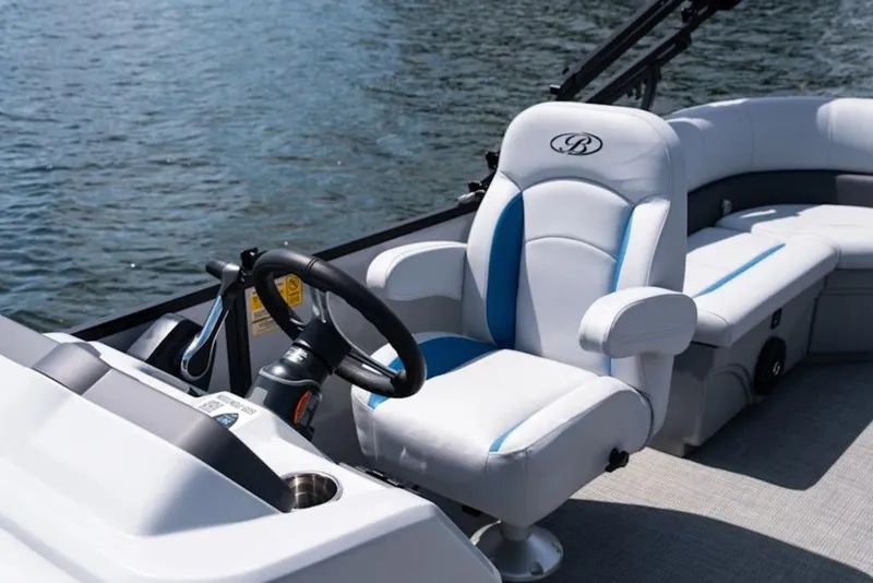 Slide: The Image of 2026 Bentley Pontoons 223 Bolt Tri-Toon interior with steering wheel and plush seating. - 10