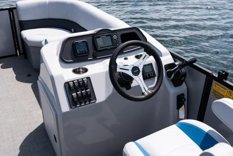 Slide: The Image of 2026 Bentley Pontoons 223 Bolt Tri-Toon steering console with modern controls on water. - 12