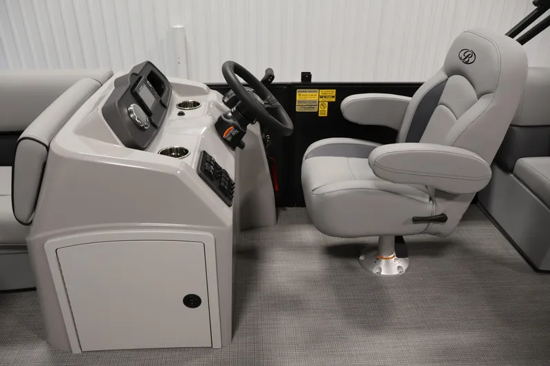 Slide: The Image of 2026 Bentley Pontoons 223 Bolt Tri-Toon helm with plush captain's chair and modern dashboard. - 17