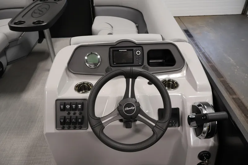 Slide: The Image of 2026 Bentley Pontoons 223 Bolt Tri-Toon dashboard with steering wheel and control panel. - 19