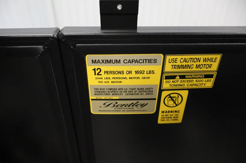 Slide: The Image of 2026 Bentley Pontoons 223 Bolt Tri-Toon capacity label, 12 persons or 1692 lbs limit. - 24