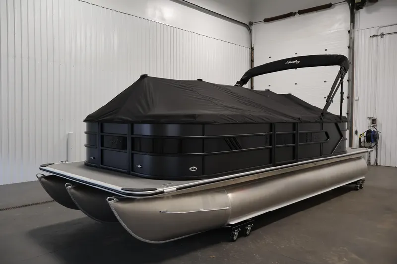 Slide: The Image of 2026 Bentley Pontoons 223 Bolt Tri-Toon with black cover in a garage setting. - 33