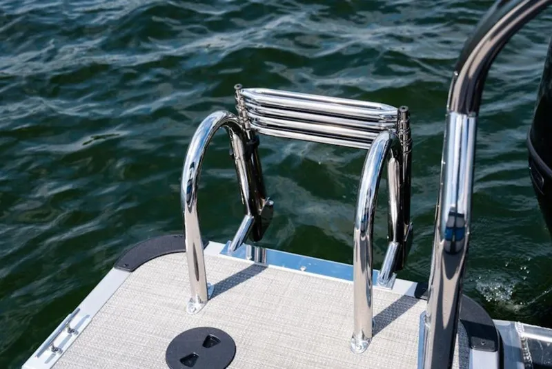 Slide: The Image of 2026 Bentley Pontoons 223 Bolt Tri-Toon with stainless steel swim ladder on water. - 9