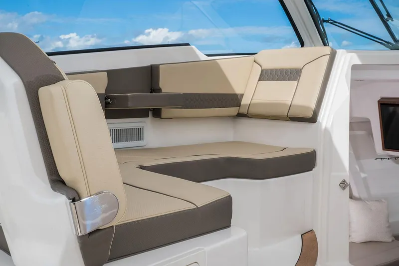 Slide: The Image of Manufacturer Provided Image: 2025 Pursuit DC 365 Dual Console interior seating with beige and brown cushions. - 12