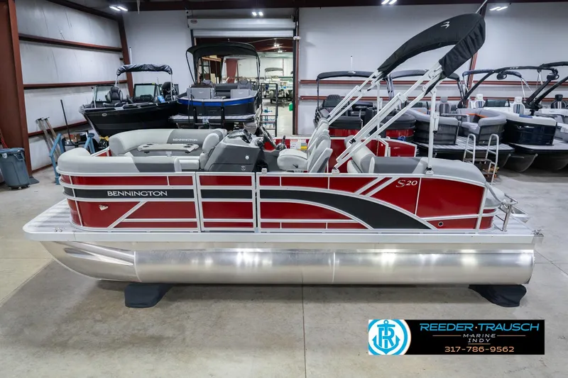 The Image of 2026 Bennington 20 SSR pontoon boat in showroom, featuring sleek red and silver design. - 0