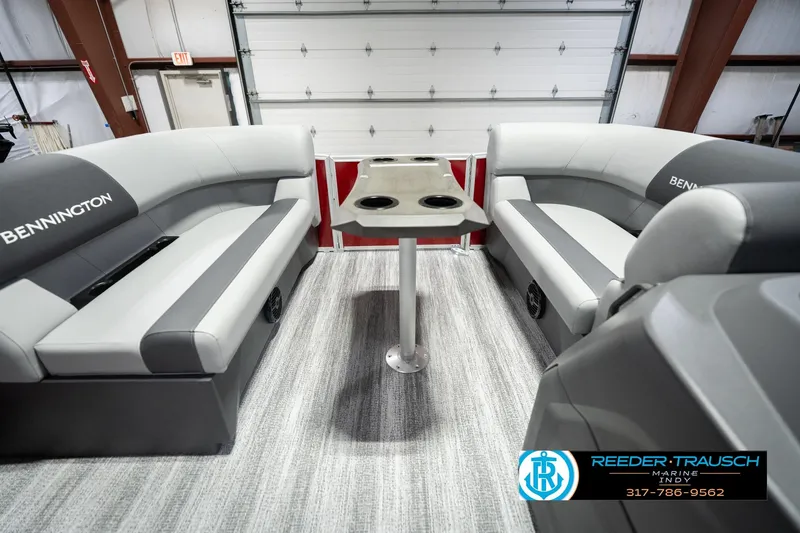 Slide: The Image of 2026 Bennington 20 SSR boat interior with gray seating and central table in a showroom. - 21