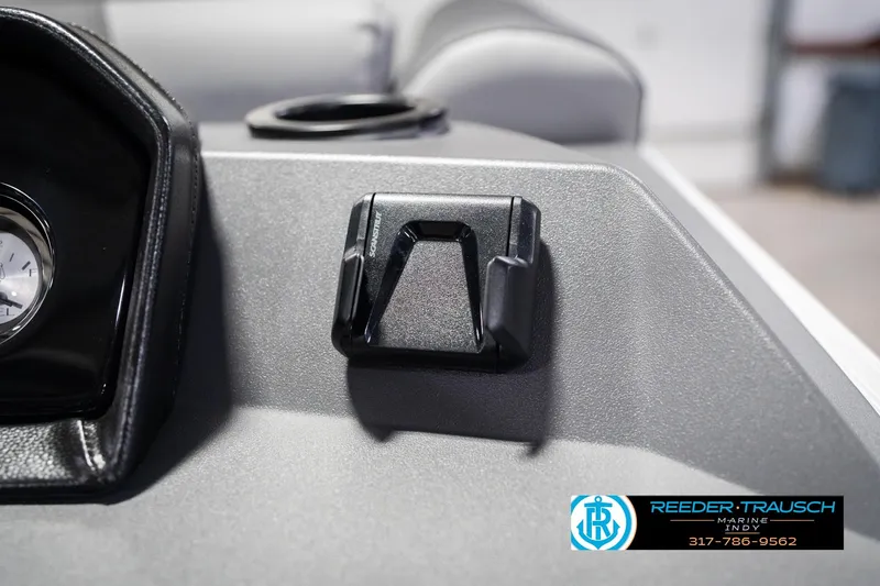 Slide: The Image of 2026 Bennington 20 SSR dashboard detail with cup holder and gauge, Reeder Trausch Marine logo. - 34