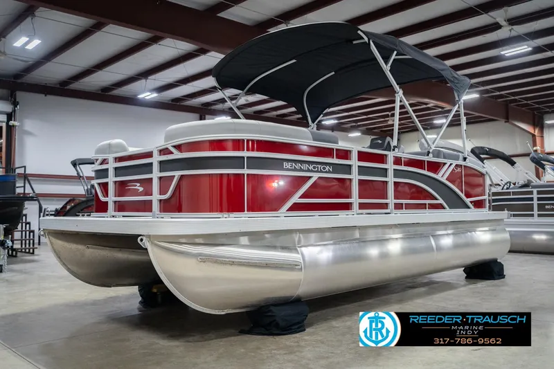 Slide: The Image of 2026 Bennington 20 SSR pontoon boat with red exterior in a showroom. - 4