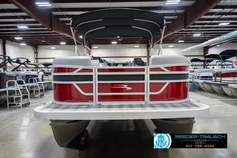 Slide: The Image of 2026 Bennington 20 SSR pontoon boat in showroom, rear view with canopy. - 5