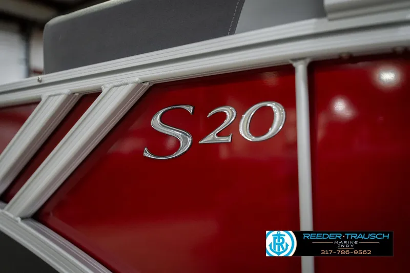 Slide: The Image of 2026 Bennington 20 SSR boat, red exterior with "S20" emblem, Reeder-Trausch Marine logo. - 54