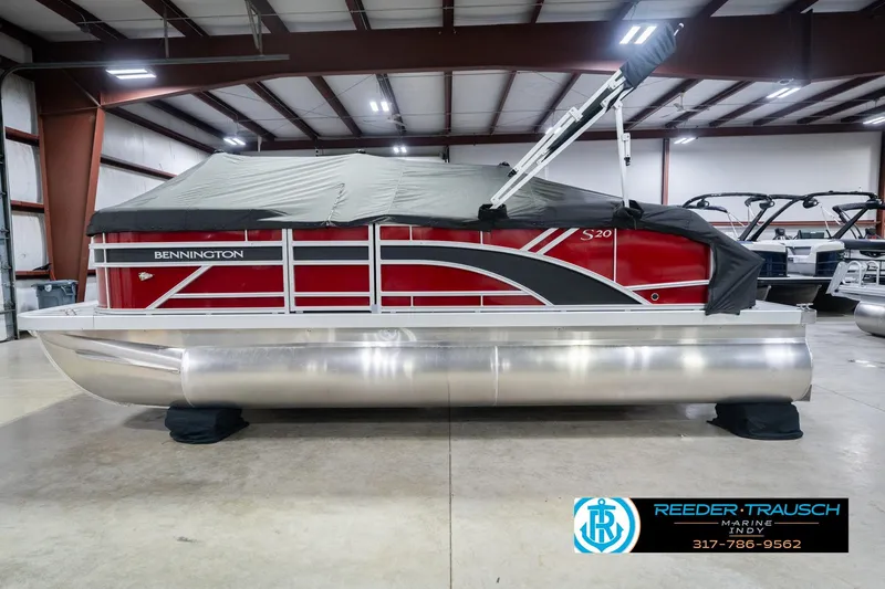 Slide: The Image of 2026 Bennington 20 SSR pontoon boat in a showroom with protective cover. - 57